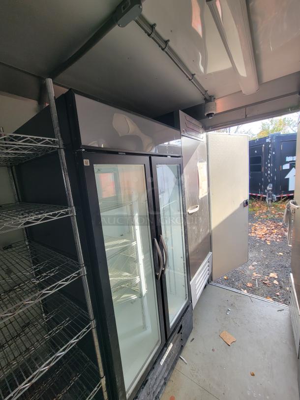 2021 Diamond Cargo trailer interior featuring Beverage-Air glass-door merchandiser and stainless steel undercounter cooler.