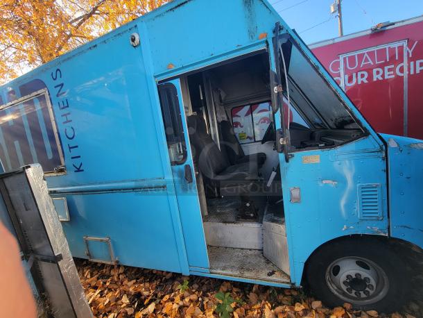 2007 Ford Utilimaster food truck with visible wear, partially open door, interior seating, and external kitchen branding.