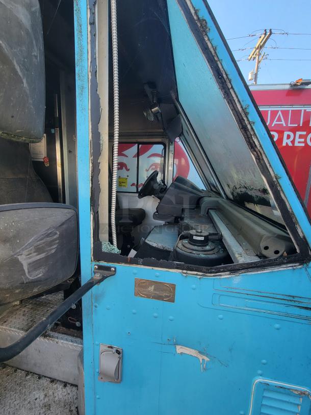 2007 Ford Utilimaster Pro-Kitchen food truck, blue exterior, showing interior and cockpit area. Needs restoration.
