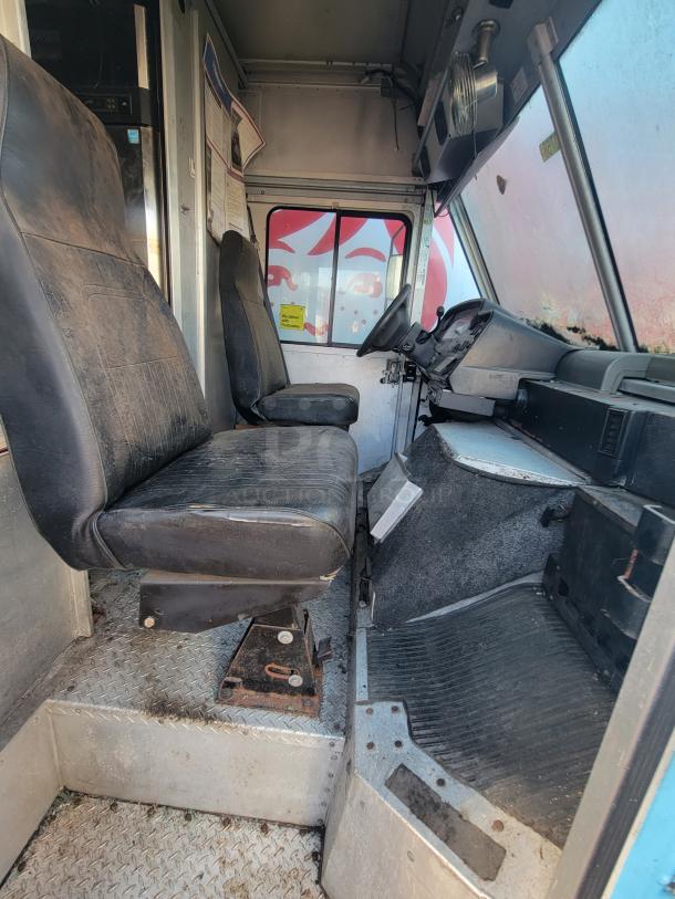 2007 Ford Utilimaster Pro-Kitchen Food Truck interior, showing driver's seat and dashboard. Visible wear on seats. Needs restoration.