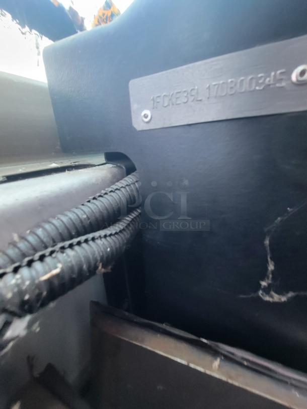 VIN plate of a 2007 Ford Utilimaster Pro-Kitchen Food Truck, visible markings: 1FCKE39L17DB00345, black interior with wiring.