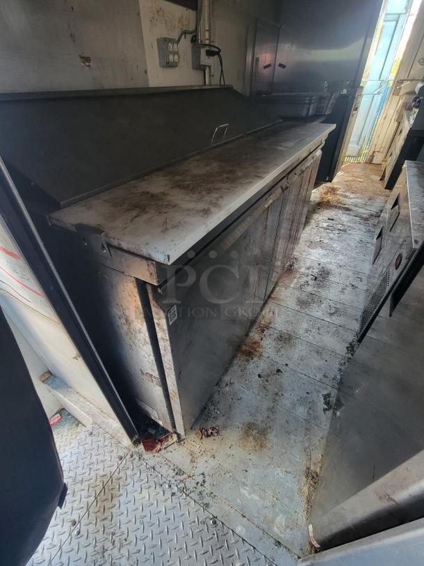 2007 Utilimaster food truck interior, showing a well-used, stainless steel kitchen station with visible wear and grime.