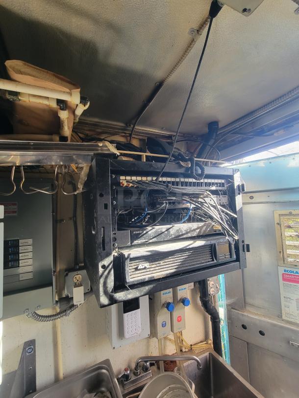 Interior of 2007 Utilimaster food truck showing high-end kitchen equipment, wiring, and controls, needing restoration.