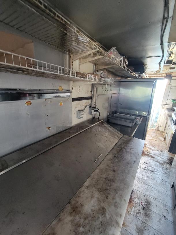 2007 Ford Utilimaster Pro-Kitchen food truck interior, high-end gear, needs restoration. Stainless surfaces and storage racks visible.