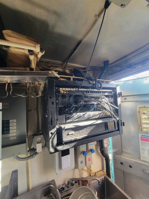 Interior of 2007 Utilimaster Pro-Kitchen Food Truck featuring complex wiring, APC equipment, and Ecolab dispensers, requiring restoration.
