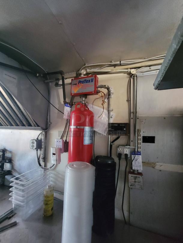 2007 Ford Utilimaster food truck interior with ProTex II fire suppression system, plastic trays, and cleaning supplies.