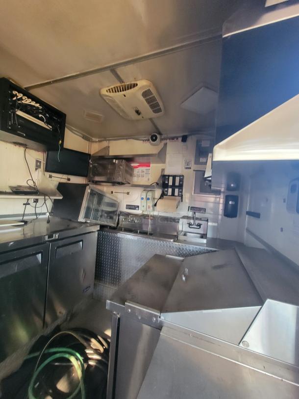 2018 STM 14-Foot Concession Trailer, equipped with commercial appliances, stainless interiors, and AC unit, ideal for catering.
