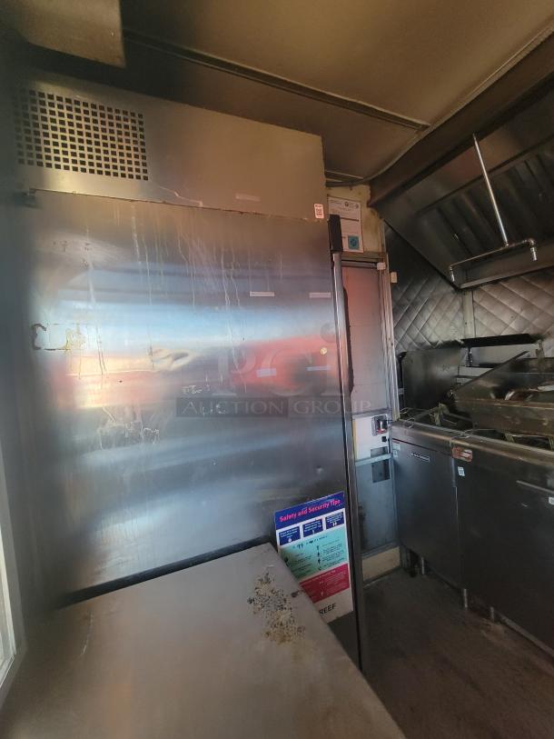 2018 STM 14-Foot Concession Trailer, stainless steel interior, equipped with commercial kitchen appliances, safety signage visible.