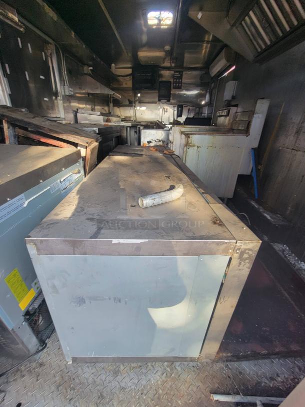 2019 Anvil 16' food trailer with severe grease fire damage, requiring full restoration; extreme grease buildup evident.