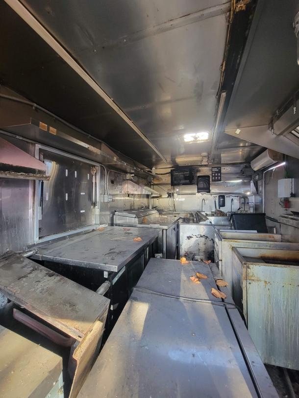 2019 Anvil 16' food trailer interior, showing severe grease buildup and smoke damage. Requires restoration or for parts.