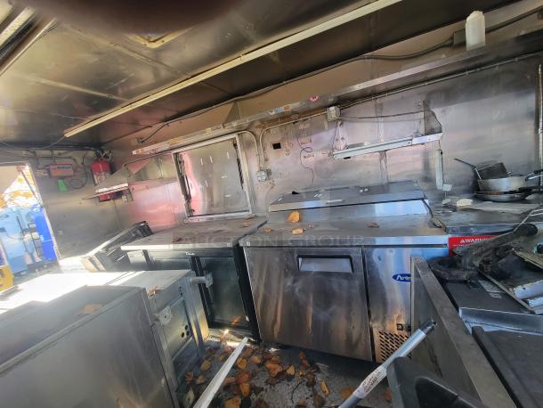 2019 Anvil 16' food trailer interior with significant grease damage, needing restoration. Contains equipment used by "NBRHD KITCHENS".