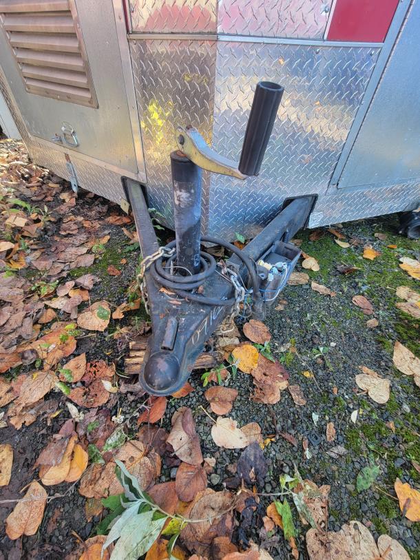 2019 Anvil 16' food trailer hitch with leaf-strewn ground. Requires restoration after internal fire damage.