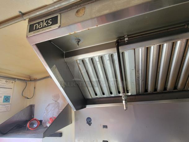 2020 16' Diamond Cargo food trailer interior with Naks ventilation hood, commercial-grade equipment, and safety certifications.