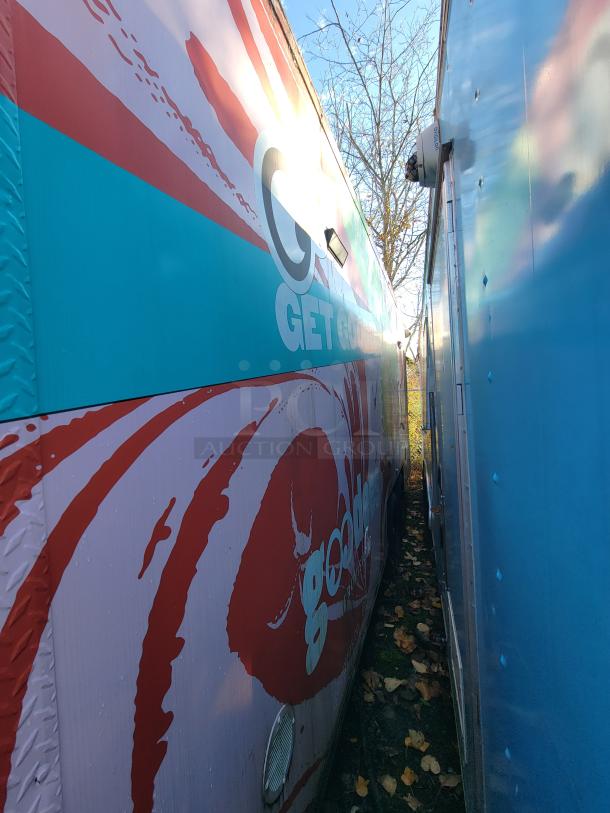 2021 SDG 20' food trailer with pink exterior wrap, "Get Goodies" text, eco-friendly refrigeration, dual axles, ready to operate.