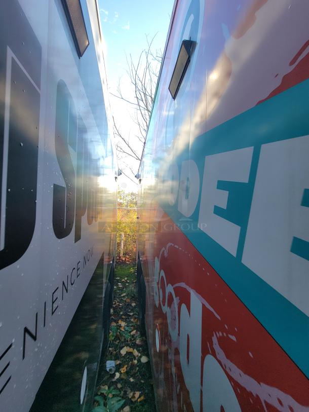 2021 pink SDG 20' food trailer, eco-friendly coolers, POS area, stainless sink, dual axles, 4,500 lbs capacity.