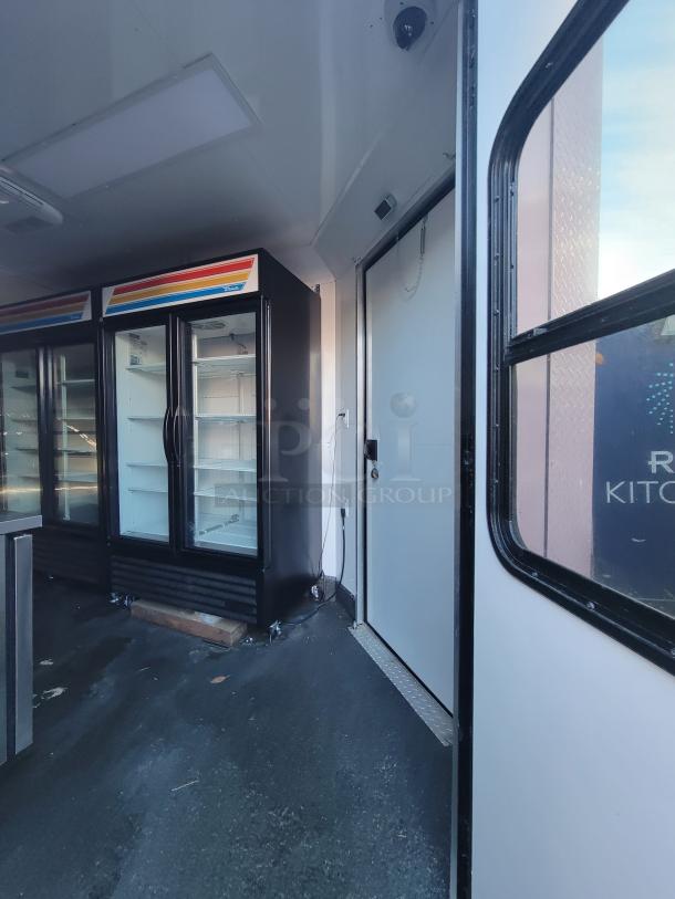 Interior of a 2021 SDG 20' mobile provisions trailer with True Refrigeration coolers, finished flooring, and retail setup.