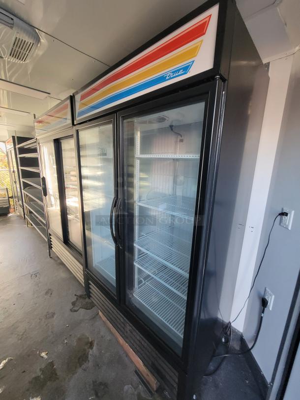 Interior of 2021 SDG 20' trailer with True Refrigeration commercial coolers, glass doors, and shelving. Fully setup for retail.