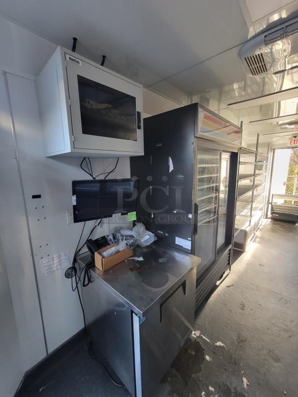 2021 SDG 20' mobile provisions trailer interior; features True Refrigeration units, counter area, POS setup, and shelving.