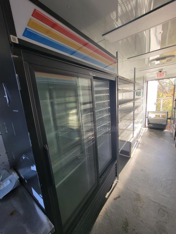 2021 SDG 20' food trailer interior with True Refrigeration coolers, shelving, POS area, and stainless sink. Ready-to-use condition.