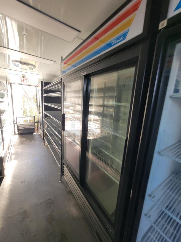 Interior of a 2021 SDG 20' mobile provisions trailer with True Refrigeration coolers, shelving, and POS area.