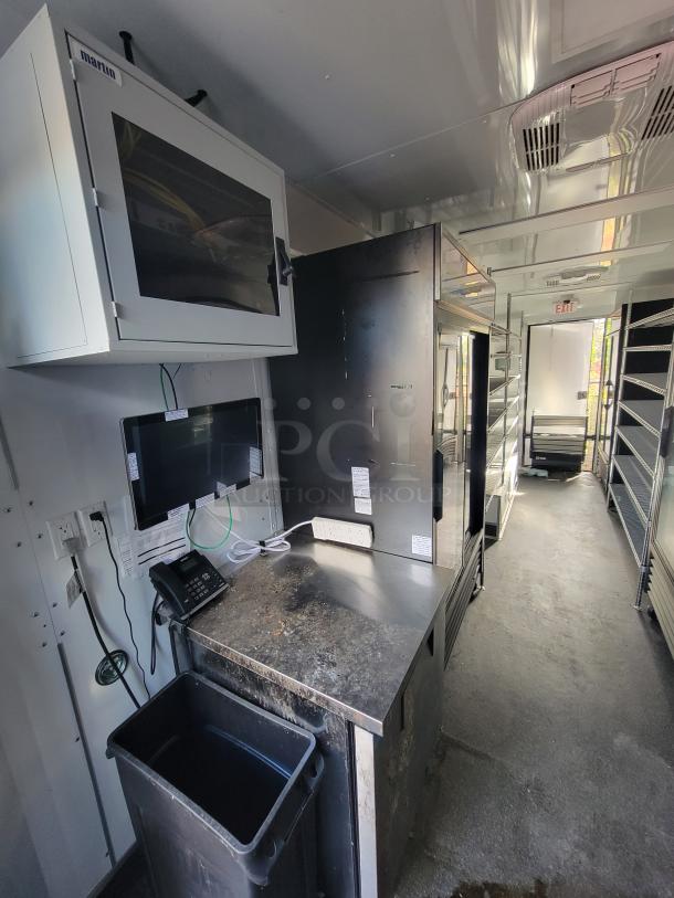 2021 20' SDG Mobile Market Trailer interior with prep sink, POS station, True refrigerators, shelving, electrical outlets.