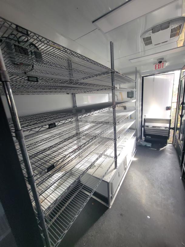 2021 SDG 20' mobile market trailer interior with shelving, True coolers, AC, prep sink, and POS station. Ideal for retail.