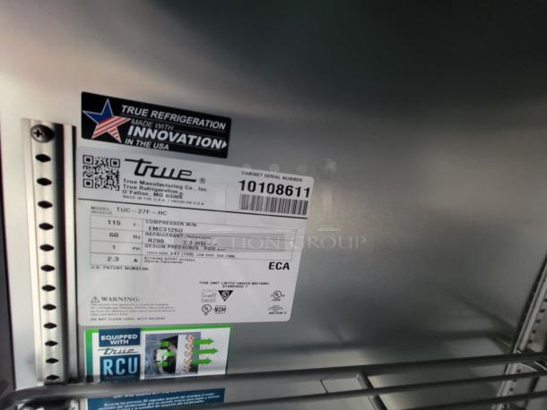 True refrigerator label inside mobile market trailer, showing model TUC-27F-HC, compressor details, and barcode.