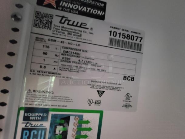 Label on True Manufacturing fridge showing model GDM-45-HC-LD, refrigerant R290, and serial number 10158077.