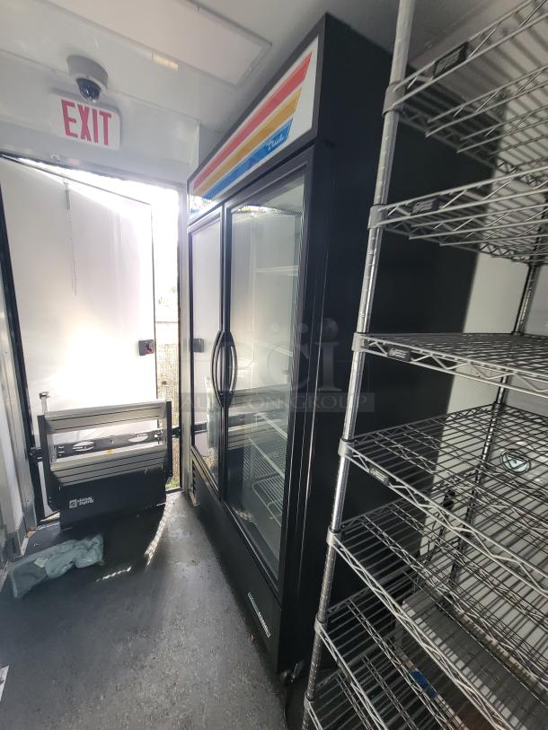 2021 20' SDG Mobile Market Trailer interior with True coolers, heavy-duty shelving, and POS station. Fully equipped.