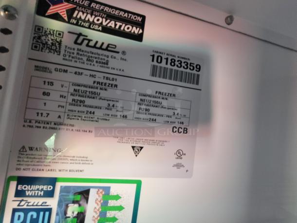 Label inside a True Manufacturing freezer, model GDM-43F-HC-TSL01, showing specifications like voltage, refrigerant type, and serial number 10183359.