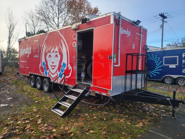 Brand new 2022 Rock Solid Cargo 28' triple-axle ghost kitchen trailer, branded with Wendy's graphics, equipped with top-tier commercial appliances.