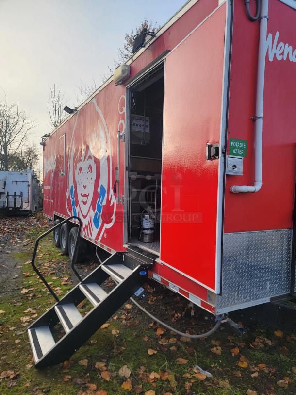 2022 Rock Solid Cargo 28' ghost kitchen trailer, never used. Features include Henny Penny fryer, Turbo Air refrigeration, Wendy's branding.