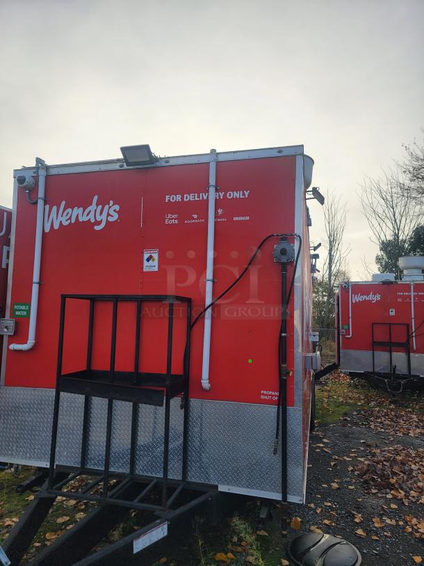Never-used 2022 Rock Solid Cargo 28' ghost kitchen trailer, red with Wendy's branding, "For Delivery Only" text visible.
