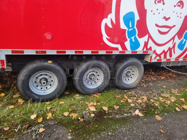 2022 Rock Solid Cargo 28' triple-axle ghost kitchen trailer, red exterior with graphic, never used, high-efficiency equipment.