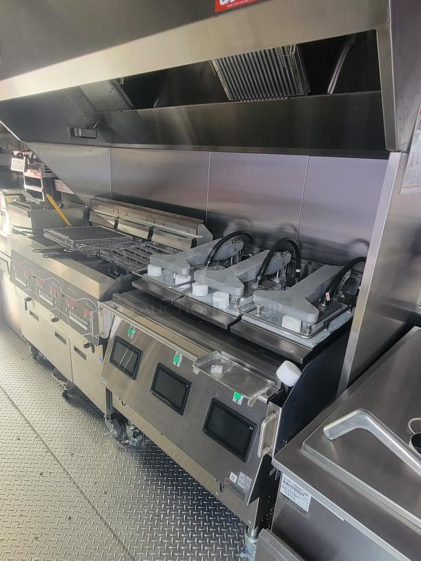 Never-used 2022 Rock Solid Cargo 28' ghost kitchen trailer with high-efficiency commercial equipment, including Henny Penny fryer, Antunes toaster, and Turbo Air refrigeration.