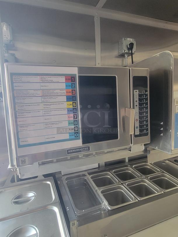 New Menumaster microwave in Rock Solid Cargo ghost kitchen trailer. Features control panel and internal trays for high-efficiency use.