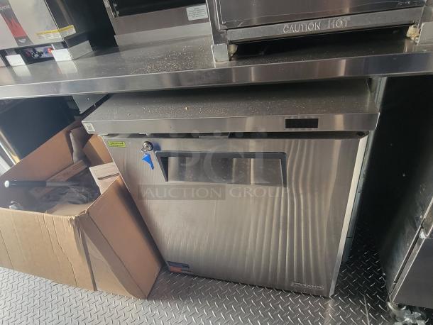 2022 Rock Solid Cargo ghost kitchen trailer interior with Turbo Air refrigeration, caution hot label, and packaging materials.