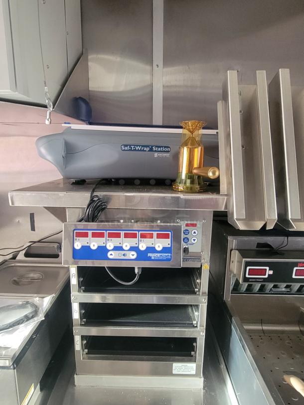 Interior of never-used 2022 Rock Solid Cargo ghost kitchen trailer with Prince Castle equipment and Saf-T-Wrap Station.