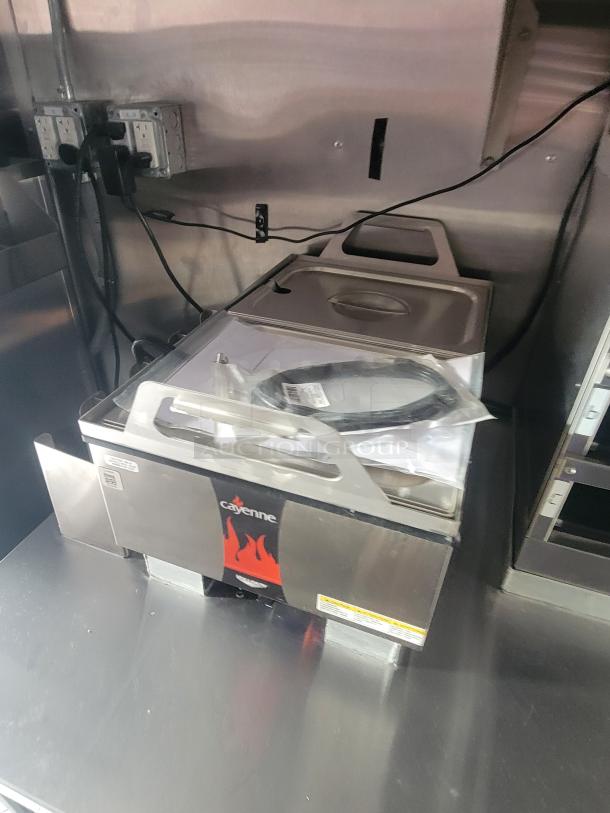 Stainless steel Cayenne toaster on counter, unused, part of 2022 Rock Solid Cargo 28' ghost kitchen trailer. Ready to use.