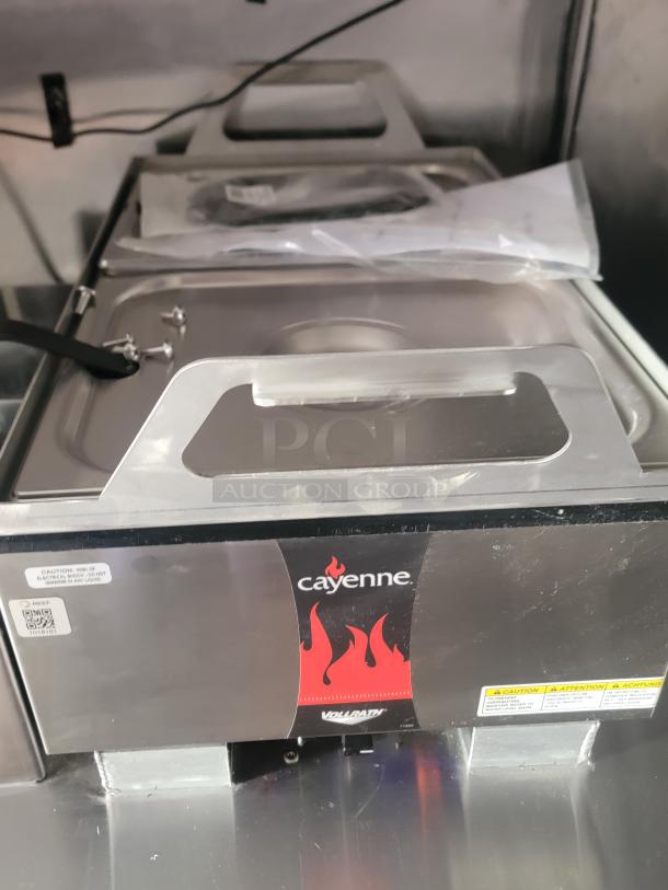 Volrath Cayenne equipment in a new 2022 Rock Solid Cargo ghost kitchen trailer. Features a sleek stainless steel finish.