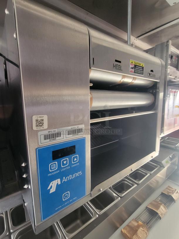 Antunes continuous speed toaster inside 2022 ghost kitchen trailer; features control panel with program, lighter, and darker settings.