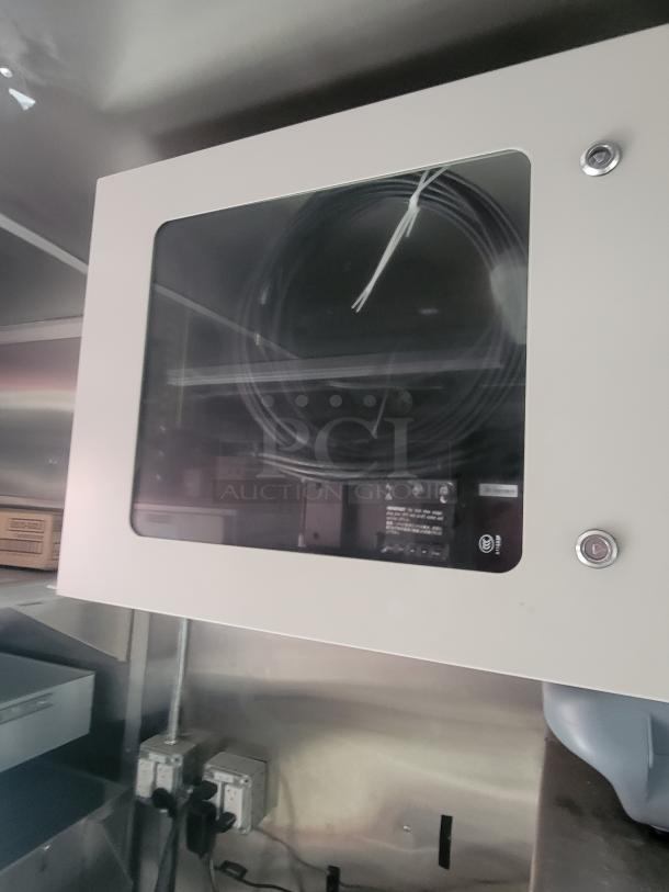 Interior of a 2022 Rock Solid Cargo 28' ghost kitchen trailer. Features a new electrical panel with visible wiring and outlets.