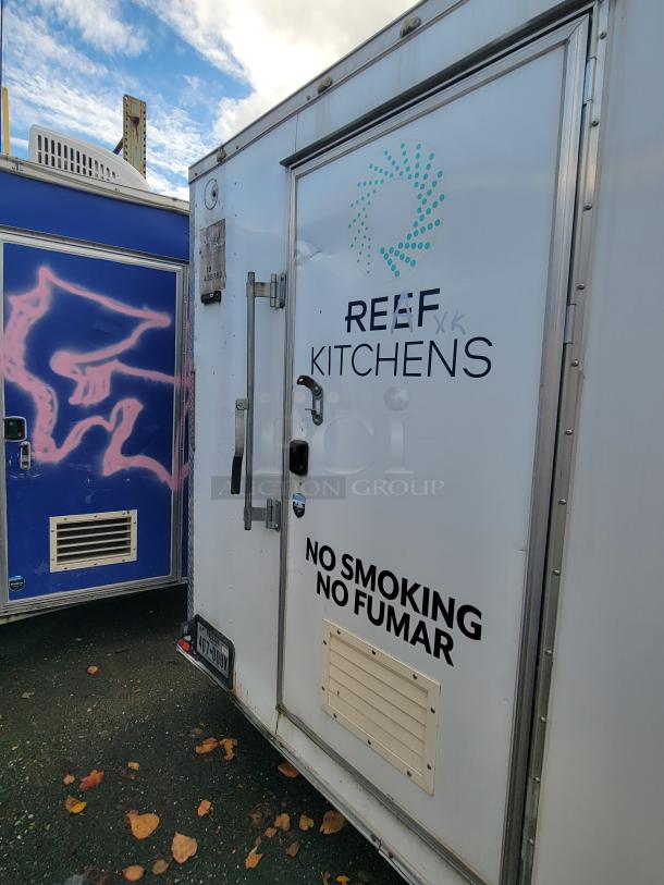 Quality Cargo Model 24 trailer with "REEF Kitchens" logo, white exterior, side vent, and "No Smoking" sign. License plate visible.
