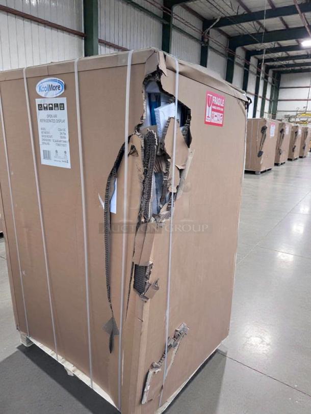 Brand new KoolMore Open Air Refrigerated Display, model CDA-13C, in damaged packaging with visible product label.