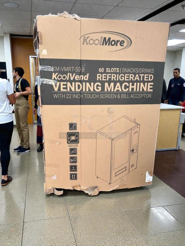 KoolMore KoolVend refrigerated vending machine KM-VMRT-50-B in packaging. Features 60 slots, touchscreen, bill acceptor. Brand new, scratch & dent.