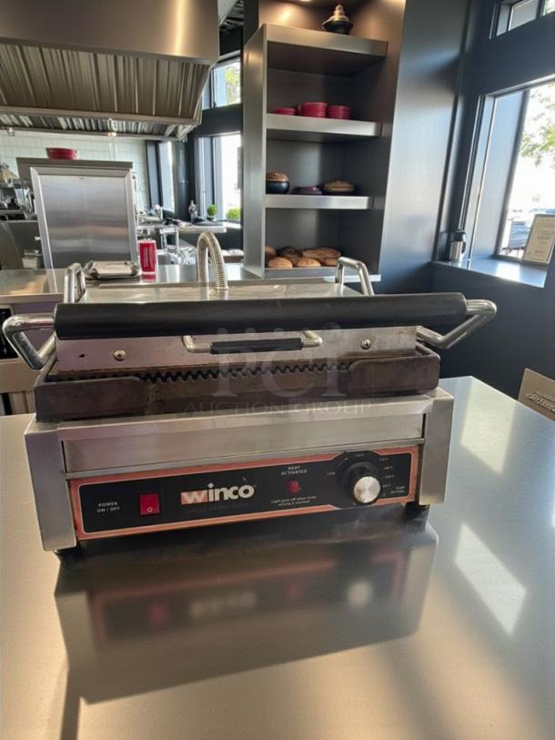 Winco EPG-1C single panini grill, immaculate condition, 120V, fully tested, countertop model. Visible control panel and branding.