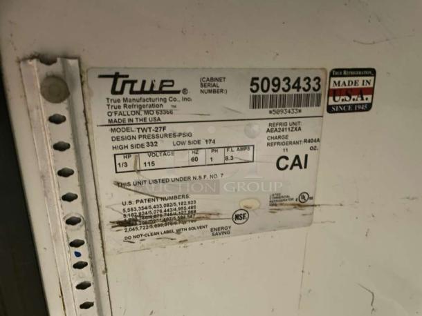 True TWT-27F undercounter freezer, premium condition, NSF certified, 115V, model label showing design pressures, and refrigerant info.