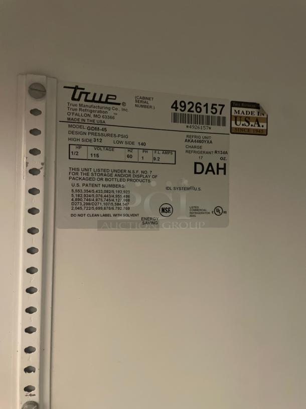 Label for True GDM-45 Merchandiser Refrigerator, 115V, showing serial number 4926157, made in USA, energy-saving features.