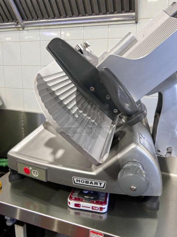 Hobart HS8 commercial meat slicer, high-grade condition, 120V, single phase, fully tested. Model visible, gray finish.