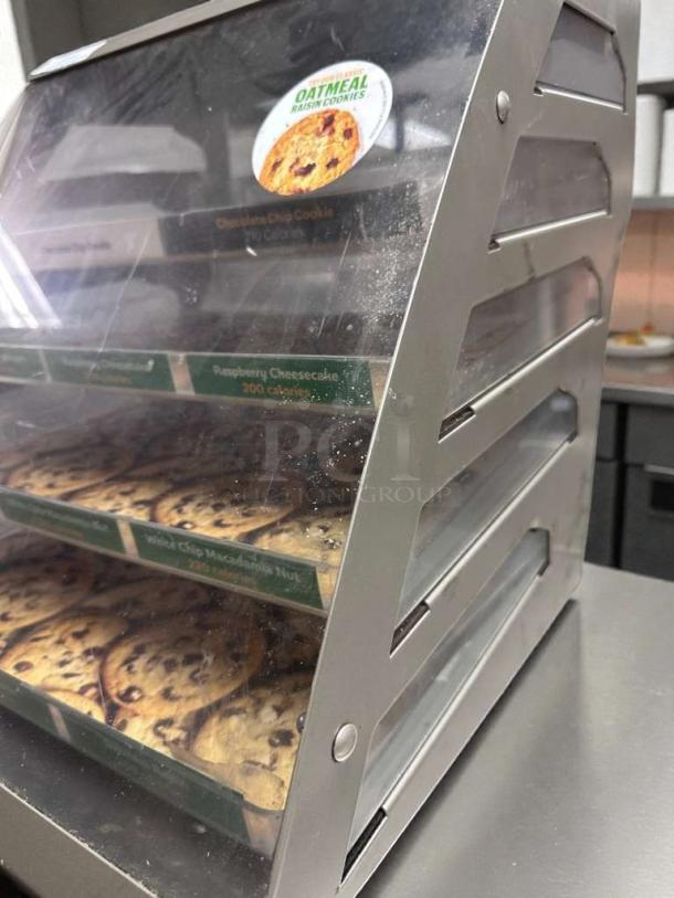 Commercial countertop multi-tier bakery display case, exceptional condition, featuring clear panels and product labels, fully operational.